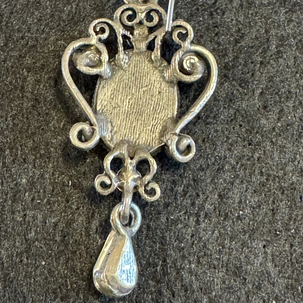 Silver tone cameo drop earrings with rhinestones